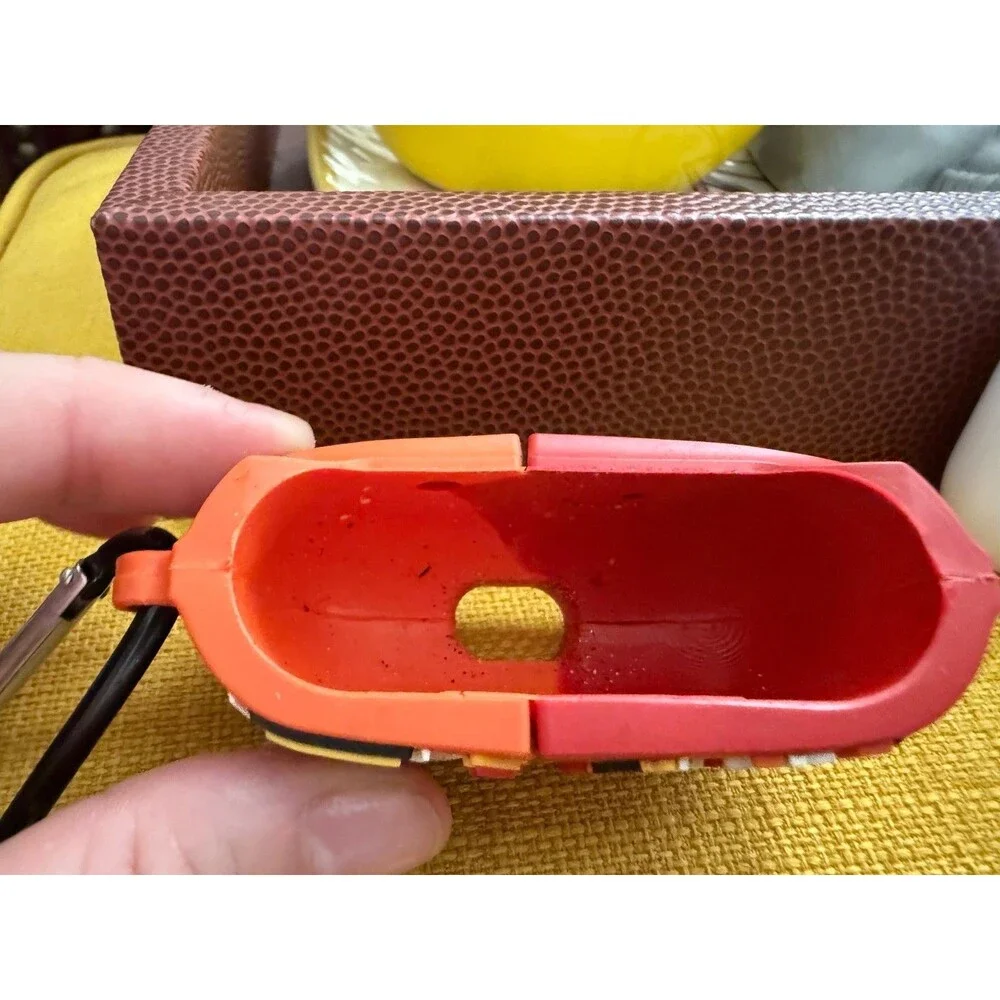 AirPods charger and half of a Cheetos case